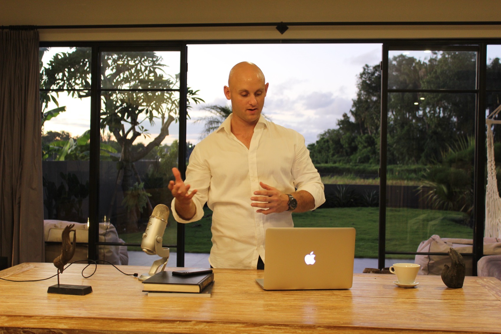 Ben Trengrove at a desk by large windows